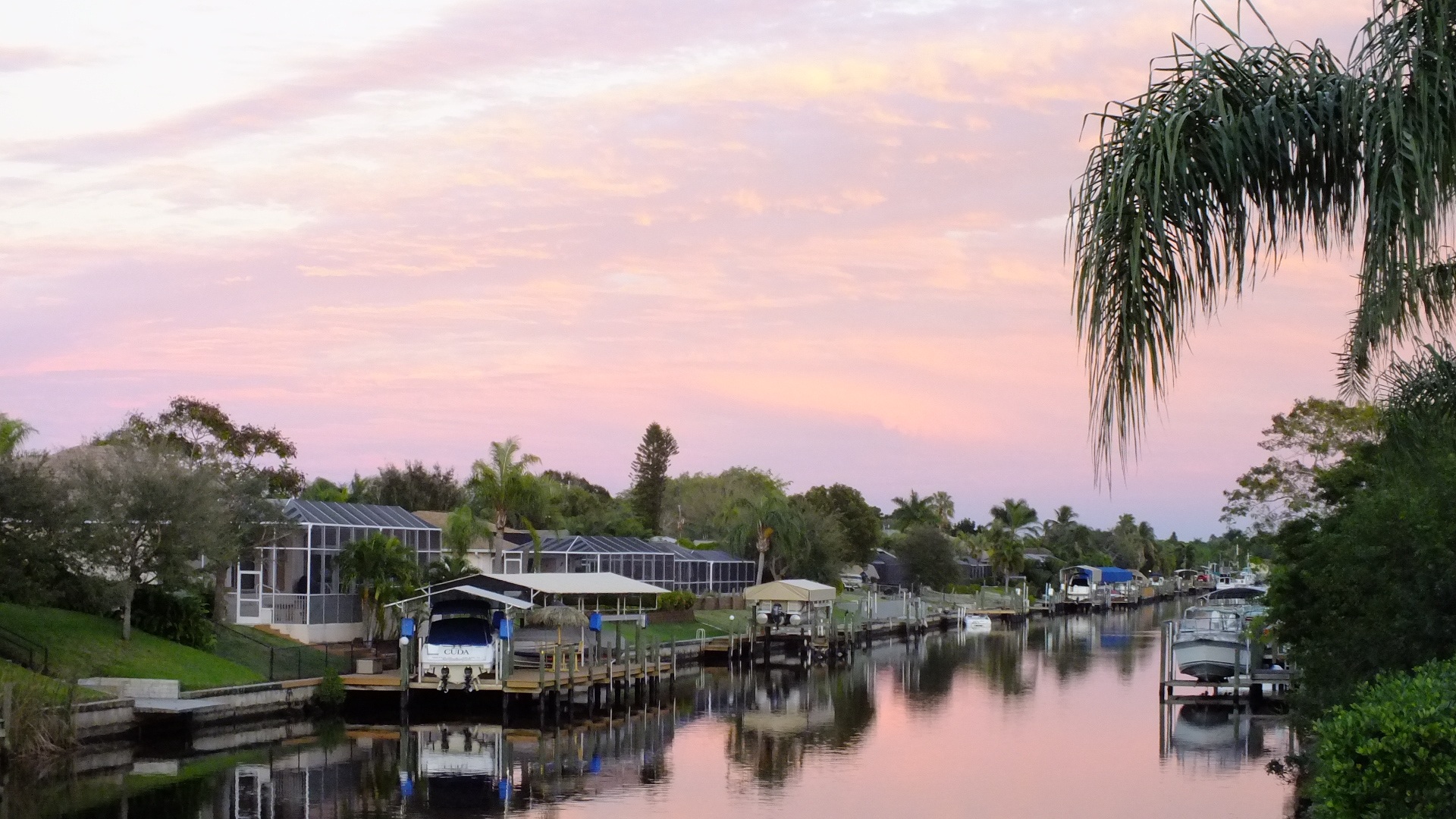 Looking down a Cape Coral canal where many boats are docked